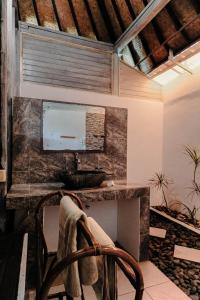 a home office with a desk and a chair at Abian Huts Dream Beach Lembongan in Nusa Lembongan +22 photos