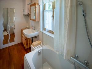a bathroom with a bath tub and a sink at Hiša pri poetu in Šempeter pri Gorici
