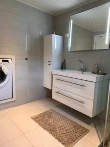 a kitchen with a sink and a washing machine at Cabin near Pulpit Rock in Strand +15 photos