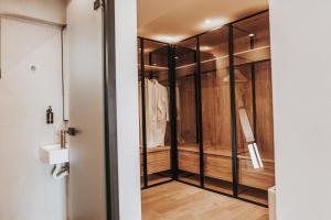 a walk in closet with glass doors and wood at Sagredo Boutique Hotel & Spa in Ágios Fokás