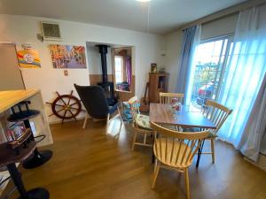 a living room with a dining room table and chairs at Takasta in Takashima