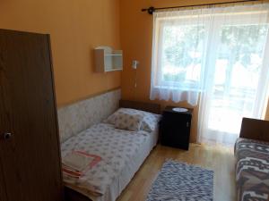 Ένα ή περισσότερα κρεβάτια σε δωμάτιο στο Bencze Vendégház Zalakaros