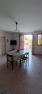 a living room with a table and two chairs at Relax e natura a due passi dal mare in Presicce