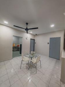 a dining room with a table and chairs and a ceiling fan at MixxHome Seremban 2, One Queen Bed, Private Bathroom in Seremban