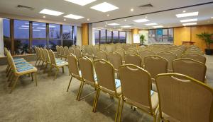 a row of chairs in a room with windows at PortoBay Rio de Janeiro in Rio de Janeiro