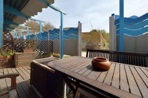 a vase sitting on a wooden table on a deck at Azzurromare Residence in Procida