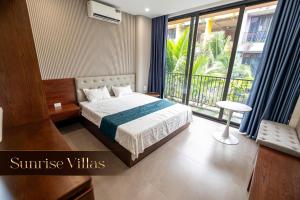 Ένα ή περισσότερα κρεβάτια σε δωμάτιο στο Sunrise Villas