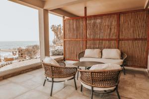 a balcony with a table and chairs and a couch at Sagredo Boutique Hotel & Spa in Ágios Fokás