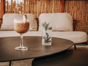 a coffee table with a drink and a wine glass at Sagredo Boutique Hotel & Spa in Ágios Fokás