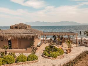 a resort on the beach with the ocean in the background at Sagredo Boutique Hotel & Spa in Ágios Fokás