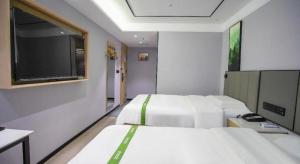 Voodi või voodid majutusasutuse GreenTree Inn LiaoCheng LinQing HaiShan Building Express Hotel toas