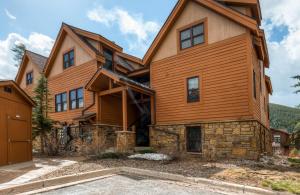 a large wooden house with a gambrel at Three-Bedroom Townhome In Keystone at Antler's Gulch in Keystone