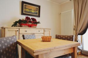 a dining room table with chairs and a table with a basket on it at Maison Carrel Elegant 7 in Breuil-Cervinia +12 photos