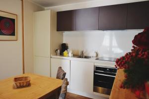 a kitchen with a table and a sink and a stove at Maison Carrel Elegant 7 in Breuil-Cervinia