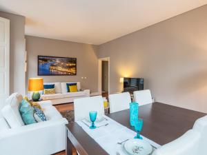 a dining room with a table and white chairs at Cardosas Boutique Apartment in Porto