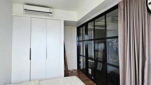 a bedroom with a bed and a large window at Condo Sea view Beach U 34 in Pattaya South +2 photos