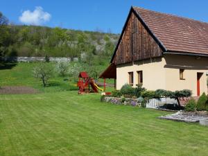 a house with a playground in the yard at Privát Lenka in Prosiek