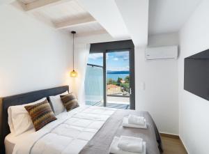 ein Schlafzimmer mit einem Bett und Meerblick in der Unterkunft Pillow Apartments in Nikiana