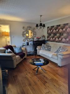 a living room with a couch and a table at Rosemount in Sligo