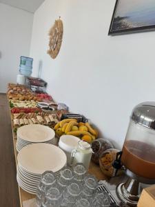 a table with plates of food and a mixer at Otto Hotel in Ksamil