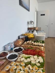 a buffet with many different types of sandwiches and vegetables at Otto Hotel in Ksamil
