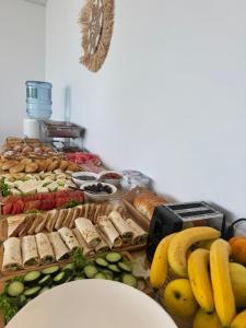 a table topped with lots of different types of food at Otto Hotel in Ksamil