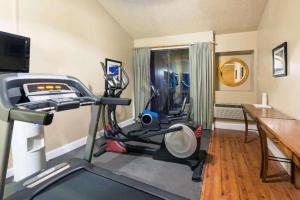 a room with a gym with a treadmill and a desk at Ramada by Wyndham Monument in Monument