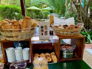 a display of bread and baskets and pastries on a table at Le Windsor, Jungle Art Hotel in Nice