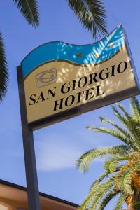 a sign for a san gregorio hotel next to a palm tree at Hotel San Giorgio in Vasto