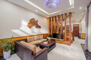 a living room with a couch and a tv at Khải Villa Private Pool 6BR Walk to Han Market and Han River in Da Nang