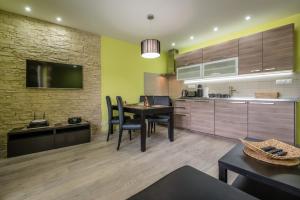 a kitchen with a table and a dining room at Apartment Vanessa - Tatranská Lomnica in Tatranská Lomnica