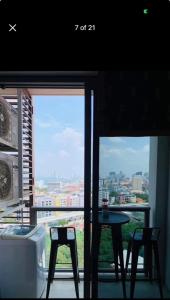 a room with a table and a view of a city at Condo Sea view Beach U14 in Pattaya South