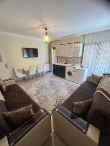 a living room with a couch and a table at Karenes KUZEY Pansıyon in Çaykara