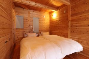 Postel nebo postele na pokoji v ubytování 石工房吉田