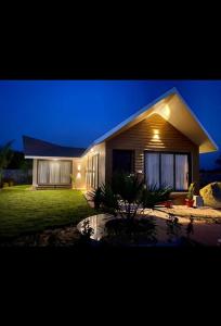 a house is lit up at night at 360 Club n Villa 