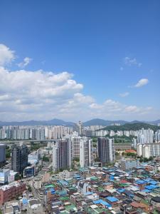 a city with tall buildings and buildings at The November Stay Guri Station in Guri
