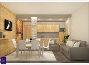 a kitchen and living room with a table and chairs at Relais Fior di Bosco in Folgaria