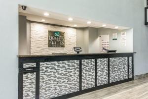 a lobby with a reception counter with a sign on a wall at Quality Suites Maumelle - Little Rock NW in Maumelle +27 photos