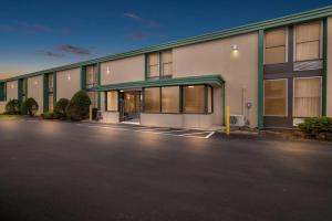 an empty parking lot in front of a building at Quality Inn Bangor Airport in Bangor