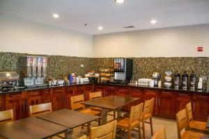 a restaurant with two tables and chairs and a counter at Country Inn & Suites by Radisson, Washington Dulles International Airport, VA in Sterling