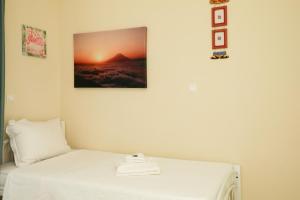 a bedroom with a bed with a picture on the wall at Aggelo's House in Lefkada Town