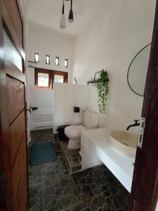 a bathroom with a toilet and a sink at Thousands of Bottles - Hostel and Trekking in Bukit Lawang +30 photos