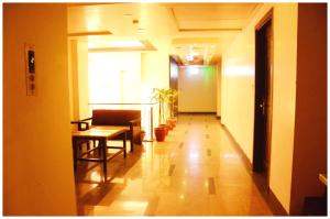 a hallway with a table and chairs in a building at A Premium Hotel FAIRWAY Near Railway Station - Well Decorated & Spacious Rooms - Lift # Restaurant # Free Parking And Free Wi-fi Available - A Top Rated Hotel In Amritsar in Amritsar +19 photos