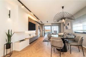 a dining room and living room with a table and chairs at La Vir deluxe- Silver & Black in Vir