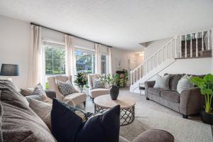 a living room with a couch and chairs at Central Family Oasis with Hot Tub & Fenced Yard in Omaha