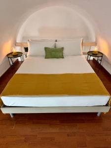 a large white bed with two candles on two tables at MiLù Sicily House in Modica