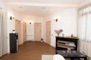 a living room with white walls and wooden floors at Hostal Excellence in Barcelona +72 photos