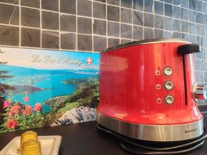 a red toaster sitting on a kitchen counter at Clubhouse in Giez