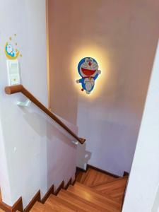 a set of stairs with a cartoon on the wall at Doraemon I-City House, Hyde Tower I-City, Seksyen 7, Shah Alam, Selangor in Shah Alam