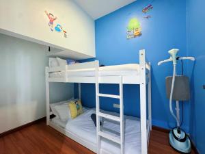 a bunk bed in a room with blue walls at Doraemon I-City House, Hyde Tower I-City, Seksyen 7, Shah Alam, Selangor in Shah Alam